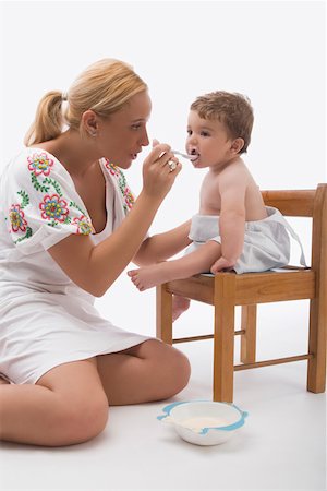 simsearch:625-02929316,k - Mid adult woman feeding her son with a spoon Stock Photo - Premium Royalty-Free, Code: 625-02267696