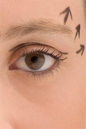 Close-up of a young woman with pre-surgical markings on her face Stock Photo - Premium Royalty-Free, Code: 625-02267764