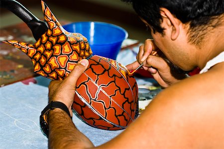 simsearch:700-03456784,k - Rear view of a man painting on ceramics, Arrazola, Oaxaca State, Mexico Stock Photo - Premium Royalty-Free, Code: 625-02267936