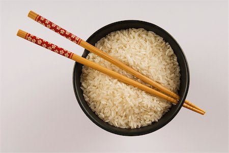 High angle view of white rice and chopsticks in a bowl Stock Photo - Premium Royalty-Free, Code: 625-02927442