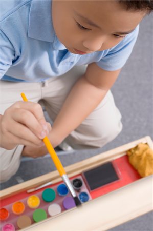 High angle view of a schoolboy painting in an art class Stock Photo - Premium Royalty-Free, Code: 625-02928957