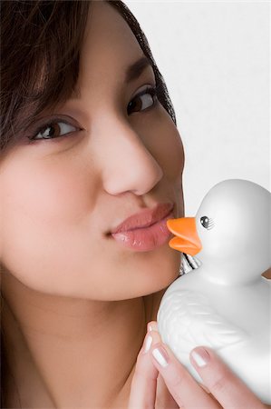 rubber duck - Portrait of a young woman kissing a toy duck Stock Photo - Premium Royalty-Free, Code: 625-02929026