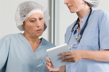 simsearch:625-02929180,k - Two male surgeons discussing a medical report Stock Photo - Premium Royalty-Free, Code: 625-02929178
