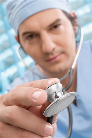 simsearch:625-02929180,k - Male surgeon holding a stethoscope Stock Photo - Premium Royalty-Free, Code: 625-02929198