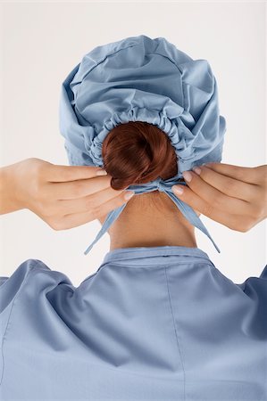surgical cap - Rear view of a female doctor wearing a surgical cap Stock Photo - Premium Royalty-Free, Code: 625-02929238