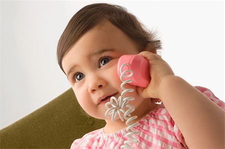 simsearch:625-02929316,k - Close-up of a girl playing with a toy phone Stock Photo - Premium Royalty-Free, Code: 625-02929294