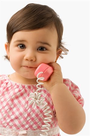 simsearch:625-02929316,k - Portrait of a girl using a toy phone Stock Photo - Premium Royalty-Free, Code: 625-02929296