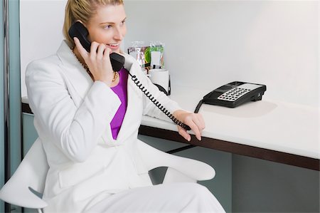 simsearch:625-02931998,k - Businesswoman talking on the telephone and smiling Stock Photo - Premium Royalty-Free, Code: 625-02929344