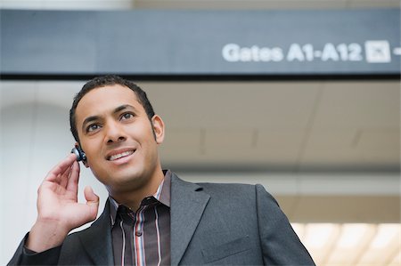 simsearch:625-02929600,k - Businessman talking on a hands free device at an airport Stock Photo - Premium Royalty-Free, Code: 625-02929463