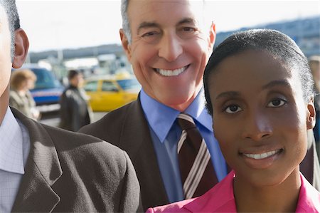 simsearch:625-02931717,k - Close-up of a businesswoman with two businessmen smiling Stock Photo - Premium Royalty-Free, Code: 625-02929555