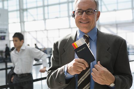 Close-up of a businessman putting a passport with an airplane ticket in his coat's pocket Stock Photo - Premium Royalty-Free, Code: 625-02929594