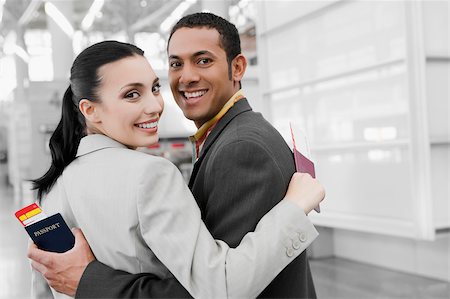 simsearch:625-02929600,k - Portrait of a businessman and a businesswoman with their arms around each other and smiling Stock Photo - Premium Royalty-Free, Code: 625-02929599
