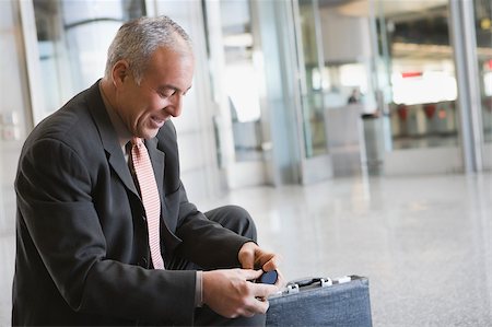 simsearch:625-02931717,k - Side profile of a businessman smiling at an airport Stock Photo - Premium Royalty-Free, Code: 625-02929609