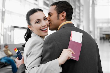 simsearch:625-02929600,k - Close-up of a businessman kissing a businesswoman at an airport Stock Photo - Premium Royalty-Free, Code: 625-02929600