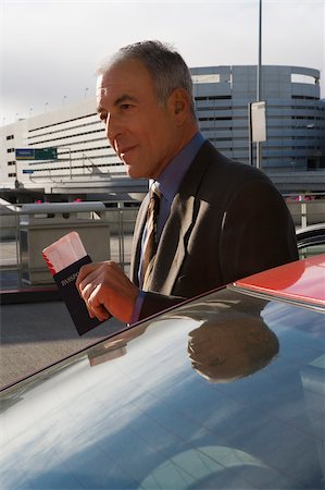 simsearch:625-02931717,k - Side profile of a businessman holding a passport with an airplane ticket Stock Photo - Premium Royalty-Free, Code: 625-02929638