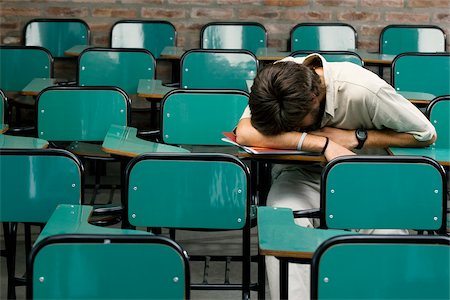 Young man napping in a classroom Stock Photo - Premium Royalty-Free, Code: 625-02929667