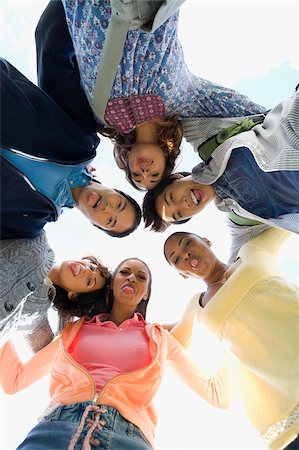 Low angle view of university students standing in a huddle Stock Photo - Premium Royalty-Free, Code: 625-02929731