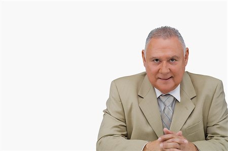 simsearch:625-02931717,k - Portrait of a businessman sitting with his hands clasped Stock Photo - Premium Royalty-Free, Code: 625-02930025