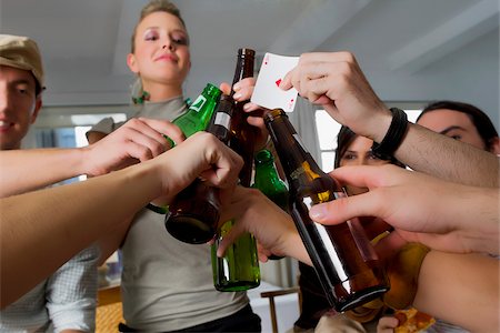 Young woman and her friends toasting with beers Stock Photo - Premium Royalty-Free, Code: 625-02930218