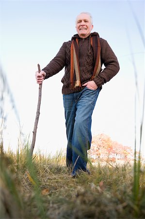 stick man - Senior man hiking in a field Stock Photo - Premium Royalty-Free, Code: 625-02930300