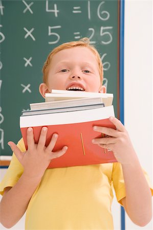 simsearch:625-01250891,k - Portrait of a schoolboy holding a stack of books and smiling Stock Photo - Premium Royalty-Free, Code: 625-02930459