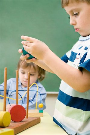 school boys side - Two boys playing with toys Stock Photo - Premium Royalty-Free, Code: 625-02930537