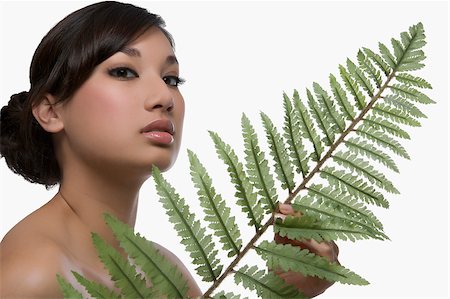 fern - Portrait of a young woman holding a fern Stock Photo - Premium Royalty-Free, Code: 625-02930731