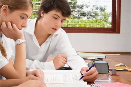 Close-up of a schoolgirl and a schoolboy studying together in a classroom Stock Photo - Premium Royalty-Free, Code: 625-02930979