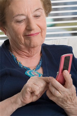 phone one person adult smile elderly - Close-up of a woman text messaging Stock Photo - Premium Royalty-Free, Code: 625-02931037