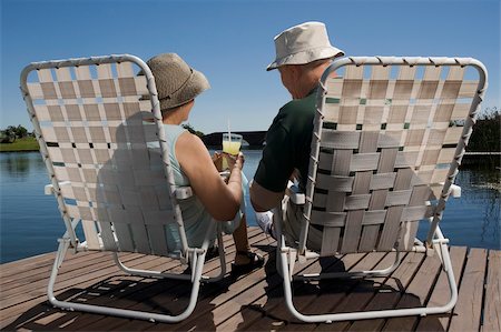 senior folding chair - Rear view of a senior couple sitting on chairs at the lakeside Stock Photo - Premium Royalty-Free, Code: 625-02931102