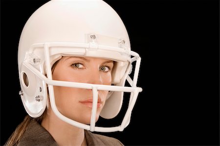 football helmet - Close-up of a businesswoman wearing a football helmet Stock Photo - Premium Royalty-Free, Code: 625-02931242