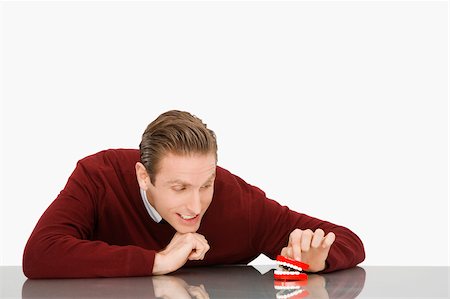 dentures - Businessman looking at dentures and smiling Stock Photo - Premium Royalty-Free, Code: 625-02931252