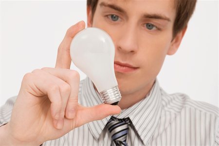 Close-up of a businessman holding a light bulb Stock Photo - Premium Royalty-Free, Code: 625-02931299