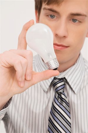 Close-up of a businessman holding a light bulb Stock Photo - Premium Royalty-Free, Code: 625-02931344
