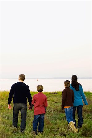 Rear view of a mid adult couple with their two children walking together Stock Photo - Premium Royalty-Free, Code: 625-02931644