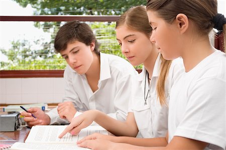 simsearch:614-06895765,k - Two schoolgirls and a schoolboy studying together in a classroom Stock Photo - Premium Royalty-Free, Code: 625-02931685