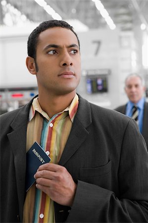simsearch:625-02931717,k - Businessman putting a passport in his pocket Stock Photo - Premium Royalty-Free, Code: 625-02931948