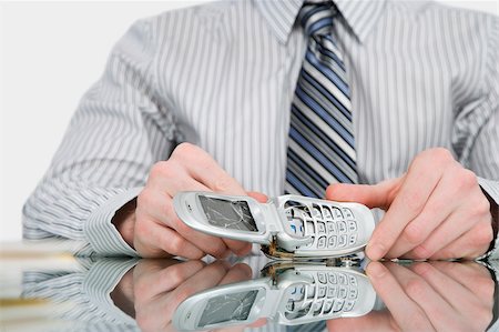 Close-up of a businessman holding a broken mobile phone Stock Photo - Premium Royalty-Free, Code: 625-02931961