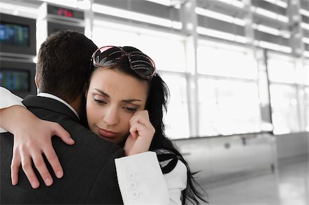simsearch:625-02929600,k - Close-up of a businesswoman embracing a businessman at an airport Stock Photo - Premium Royalty-Free, Code: 625-02932031