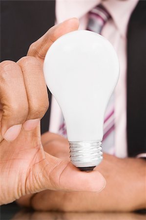 Close-up of a businessman holding a light bulb Stock Photo - Premium Royalty-Free, Code: 625-02932150