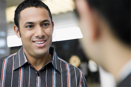 simsearch:625-02929600,k - Close-up of a businessman talking to another businessman and smiling Stock Photo - Premium Royalty-Free, Code: 625-02932180