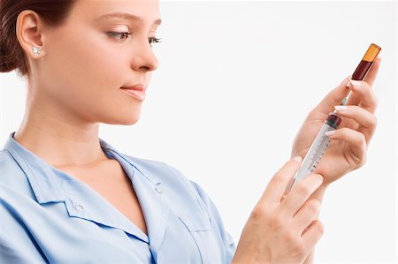 female smirk - Close-up of a female doctor filling a syringe from a vial Stock Photo - Premium Royalty-Free, Code: 625-02932223