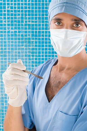 simsearch:625-02929180,k - Portrait of a male surgeon holding a scalpel Stock Photo - Premium Royalty-Free, Code: 625-02932265