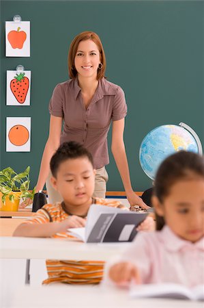 Female teacher teaching her students in a classroom Stock Photo - Premium Royalty-Free, Code: 625-02932335