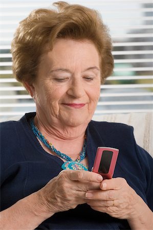 phone one person adult smile elderly - Close-up of a senior woman text messaging Stock Photo - Premium Royalty-Free, Code: 625-02932384