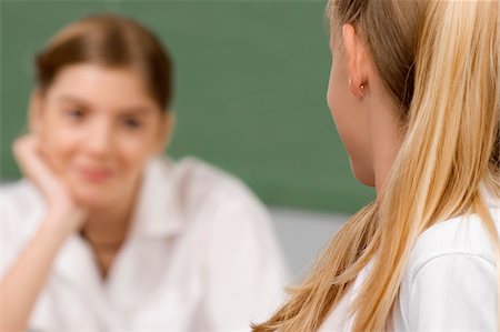 simsearch:614-06895765,k - Two schoolgirls looking at each other in a classroom Stock Photo - Premium Royalty-Free, Code: 625-02932414
