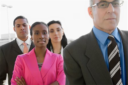 simsearch:625-02931717,k - Two businessmen standing at an airport with two businesswomen Stock Photo - Premium Royalty-Free, Code: 625-02932531