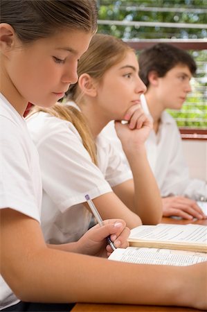 simsearch:614-06895765,k - Two schoolgirls and a schoolboy studying in a classroom Stock Photo - Premium Royalty-Free, Code: 625-02932611