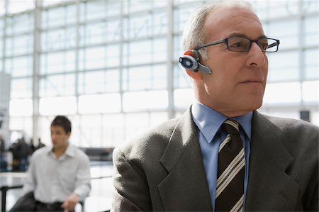 simsearch:625-02931717,k - Close-up of a businessman wearing a hands free device at an airport Stock Photo - Premium Royalty-Free, Code: 625-02932677