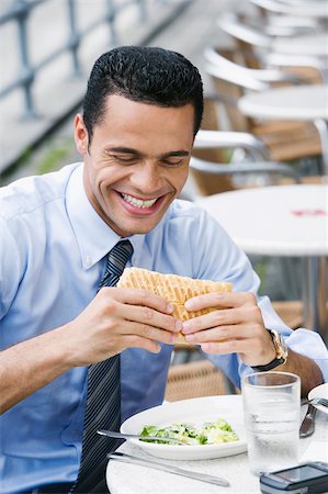 simsearch:625-01261270,k - Close-up of a businessman eating a cheese sandwich and smiling Stock Photo - Premium Royalty-Free, Code: 625-02932895